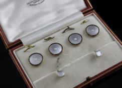 A cased Edwardian 18ct gold, blue enamel, mother of pearl and split pearl four piece dress stud set,