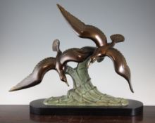 An Art Deco patinated metal figure group modelled as two seagulls on a crest of a wave, 22in. An Art