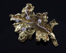 An 18ct textured gold and diamond set brooch, 2in. An 18ct textured gold and diamond set brooch,