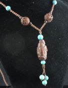 A carved coquilla nut and turquoise bead necklace, 33in. A carved coquilla nut and turquoise bead