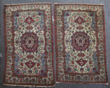 A pair of Kashan rugs, 7ft by 4ft 6in & 6ft 11in by 4ft 6in. A pair of Kashan rugs, with central