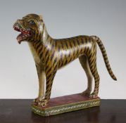 An Indian carved and painted wood model of a tiger, overall 12in. An Indian carved and painted
