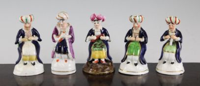 Five small Staffordshire pottery figures of seated Turkish musicians, 4.25 - 4.5in. Five small