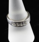 A modern 18ct white gold and seven stone emerald cut diamond half hoop ring, size P. A modern 18ct