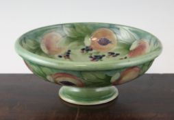 A Moorcroft Pomegranate pattern footed shallow bowl for Liberty & Co., c.1912, 9.8in. A Moorcroft