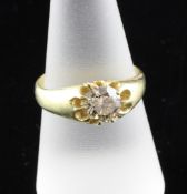 An 18ct gold gypsy set solitaire diamond ring, size P. An 18ct gold gypsy set solitaire diamond