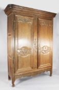 A 19th century French carved oak armoire, W.5ft 3in. H.7ft 3in. A 19th century French carved oak