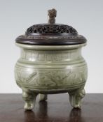 A Chinese celadon censer, Ming Dynasty or earlier, wood stand and cover, the pot bellied body