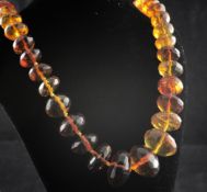 A single strand graduated facetted shaped amber bead necklace, 22.5in.