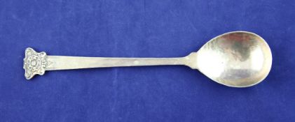 An Edwardian Arts & Crafts silver spoon, by Omar Ramsden & Alwyn Carr, of planished tapering form,
