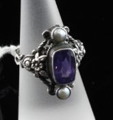 A silver, purple sapphire and cultured pearl set dress ring, with pierced foliate shank, size M.