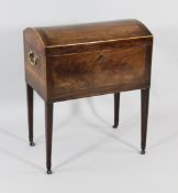 A George III flame mahogany dome top cellaret, with brass carrying handles, on square tapered legs