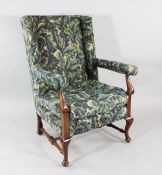 A Victorian walnut open armchair, with William Morris blue floral fabric, cabriole legs and turned H