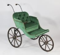 A Victorian black painted wrought iron pram, with three spoke wheels and green buttoned upholstery