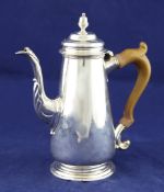 A George II silver coffee pot, of tapering form with later? engraved armorial and acanthus leaf