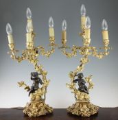 A pair of French ormolu and bronze four light candelabra, late 19th century, modelled as a semi clad