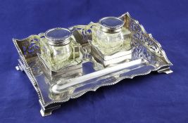 A George V silver desk inkstand, of rectangular form, with pierced three quarter gallery and