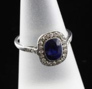 A 1920`s platinum, sapphire and diamond cluster dress ring, with diamond set shoulders, size L.