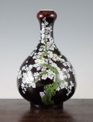 A Chinese enamelled sang de boeuf bottle vase, with garlic shaped neck, decorated with a gnarled