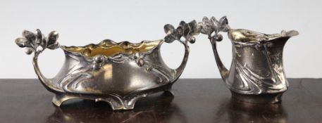 A Paul Follot for F.W. Quist Art Nouveau silvered pewter sugar bowl and cream jug, marks to base,