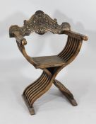 A Continental carved walnut `X` frame chair