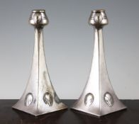 A pair of WMF Albin Muller Art Nouveau pewter candlesticks, with stylised oval decoration and