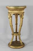 A Victorian circular marble top and carved giltwood torchere, with scroll legs, with ram`s mask