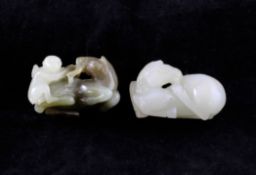 Two Chinese jade figures of horses, 18th / 19th century, the first of white jade in recumbent pose