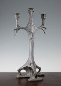 An unusual Art Nouveau pewter three branch candelabra, with sinuous decoration and three part