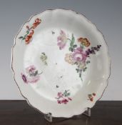 A Chelsea red anchor circular dish, c.1756, with petalled rim and floral decoration, 9.5in.