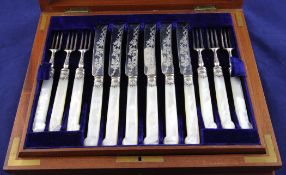 A mahogany cased set of twelve pairs of Victorian mother of pearl pistol handled silver dessert
