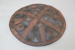 An Indo Persian iron bound and black painted hide circular dahl, W.14in.