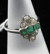 A 1920`s platinum, emerald and diamond cluster dress ring, of lozenge form, size M.