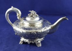 An early Victorian silver teapot, of squat circular form, with floral finial and embossed with