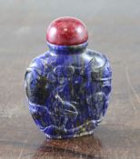 A Chinese lapis lazuli snuff bottle, of flattened ovoid form, carved in relief with a sage by a