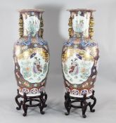 A pair of massive Chinese famille rose vases, each decorated with ladies amid flowers, in shaped