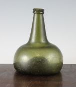 An olive green glass onion wine bottle, early 18th century, with central raised pontil, short