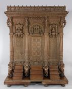 A large carved Indian sandalwood temple screen, profusely carved with various figures, animals and