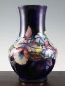 A Walter Moorcroft `Orchid` large baluster vase, on cobalt blue ground, inscribed `W.M` and `W