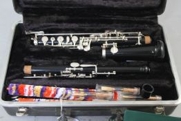 A Boosey & Hawkes Imperial blackwood oboe and case, together with a modern Oboe by Bundy