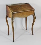 A French rosewood and marquetry inlaid bureau de dame, on scroll legs with gilt brass mounts, W.
