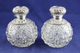 A pair of Edwardian repousse silver mounted hobnail cut glass scent bottles with stoppers, of
