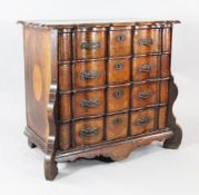 An 18th century Dutch oak and marquetry inlaid serpentine chest, of four drawers, with shaped