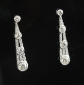 A pair of platinum and diamond set cluster drop earrings, of teardrop design, the total diamond