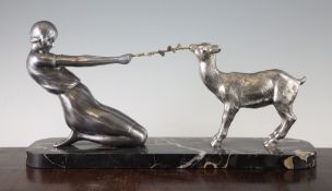 A French Art Deco polished metal figure group of a young girl and a goat, on veined black marble