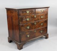 An early 18th century walnut and feather banded chest, of two short and three long drawers with