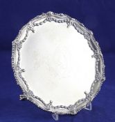 A George III silver waiter, of circular form, with engraved armorial and rim decorated with swags,