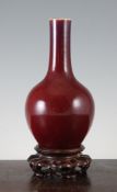 A Chinese flambe glazed bottle vase, 19th century, with predominantly sang de boeuf ground, 8.75in.;