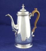 A George II silver coffee pot, of tapering form, with acanthus leaf capped spout and turned