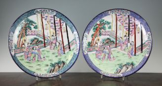 A pair of Canton enamel dishes, Republic period, each decorated with figures in a garden pavilion,